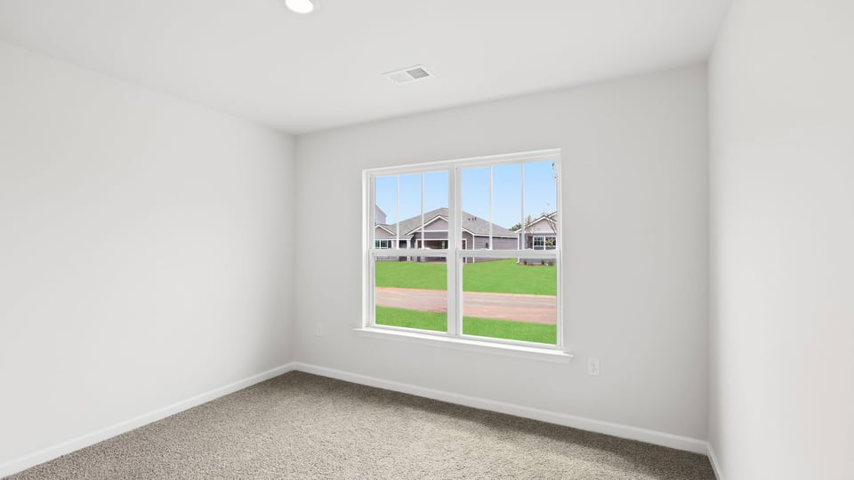 Bedroom with carpet and window.
