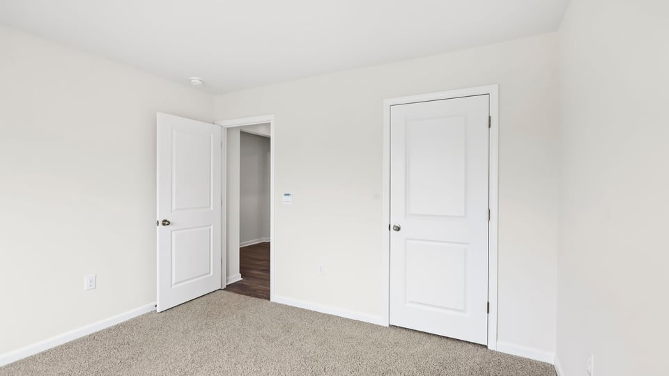 Bedroom with carpet and window.
