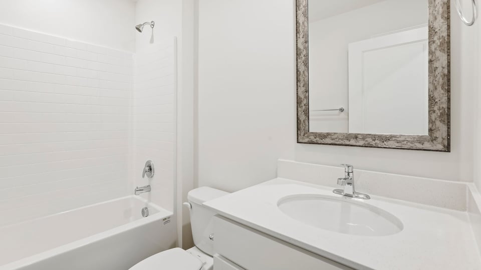 Bathroom with single vanity sink and bathtub.