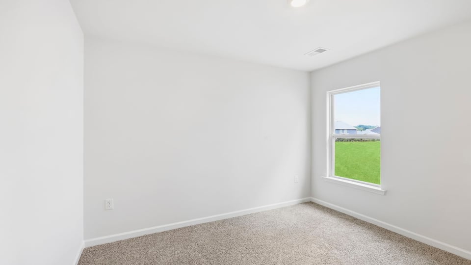 Bedroom with carpet and window.