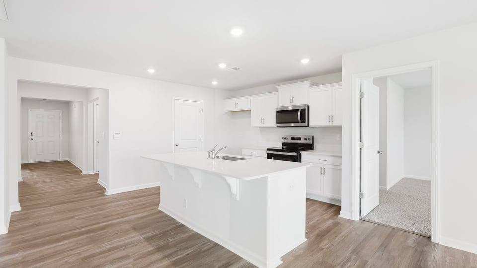 Kitchen and island with quartz countertops.