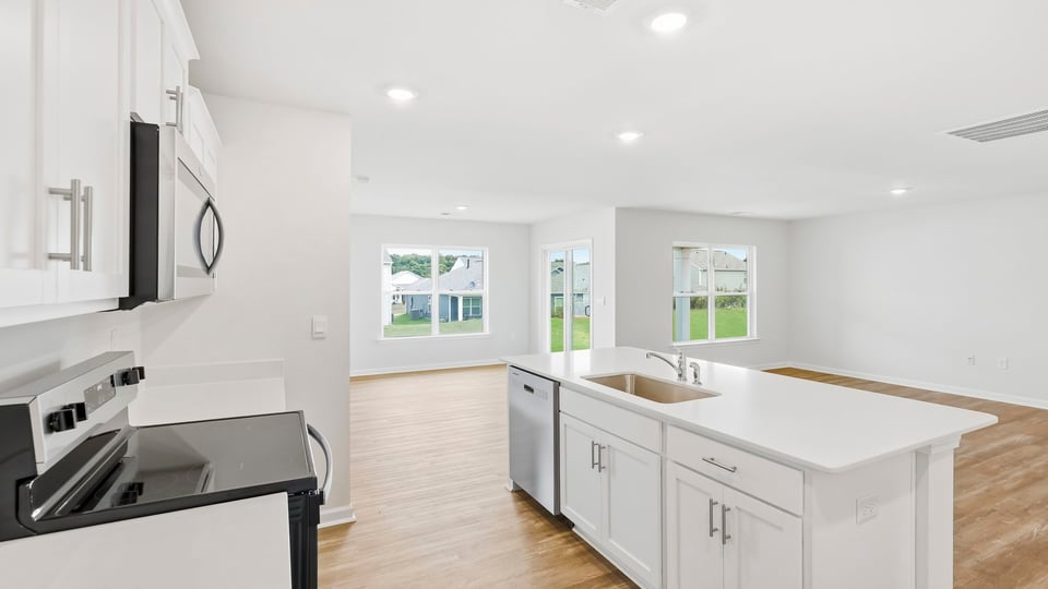 Kitchen and island with quartz countertops.