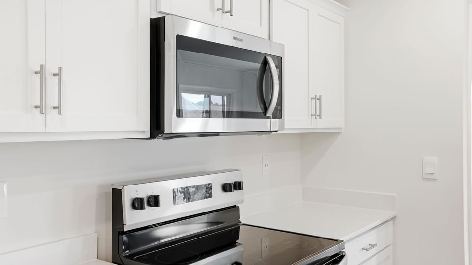 Kitchen and island with quartz countertops.