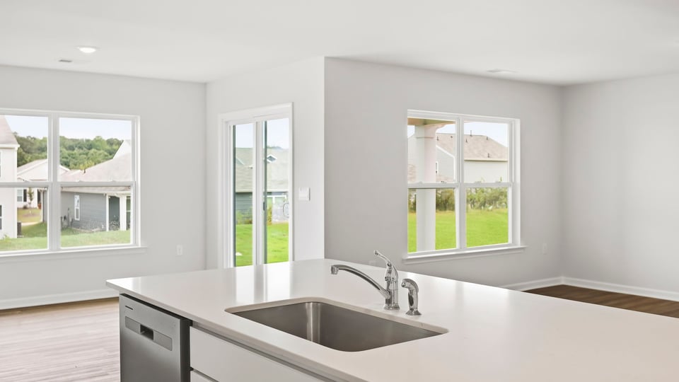 Kitchen and island with quartz countertops.