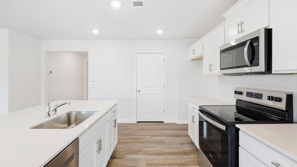 Kitchen and island with quartz countertops.