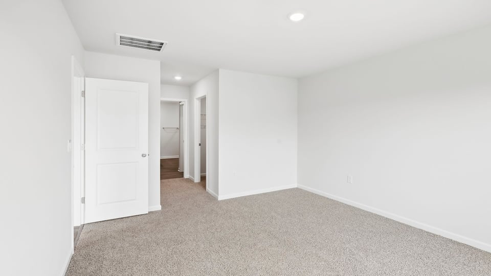 Bedroom with carpet and window.