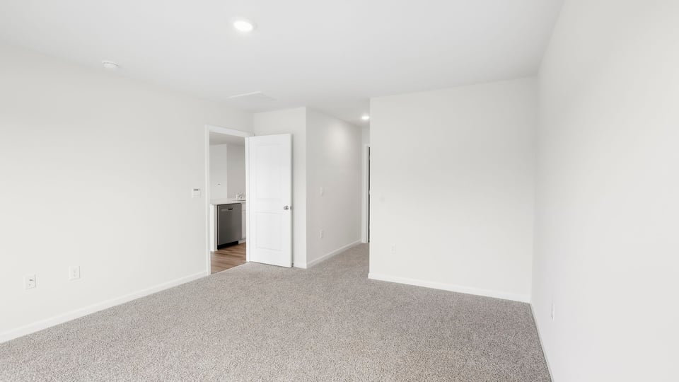 Bedroom with carpet and window.