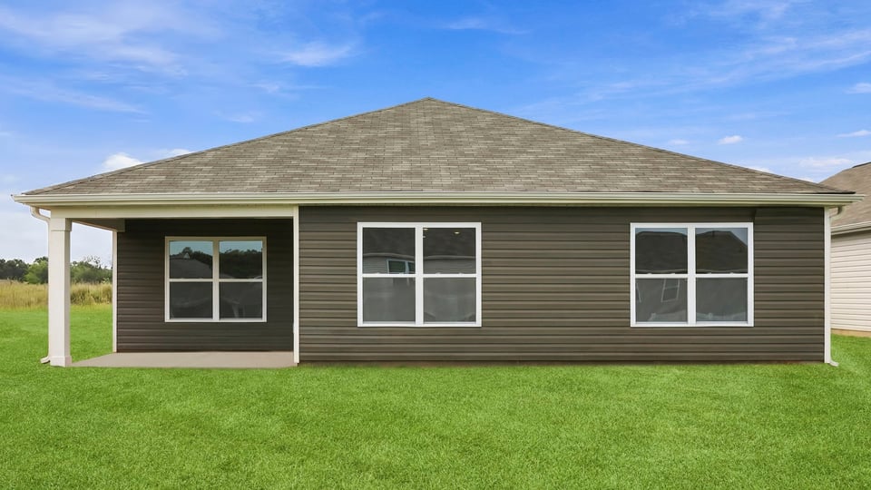 Back exterior of home with large backyard.