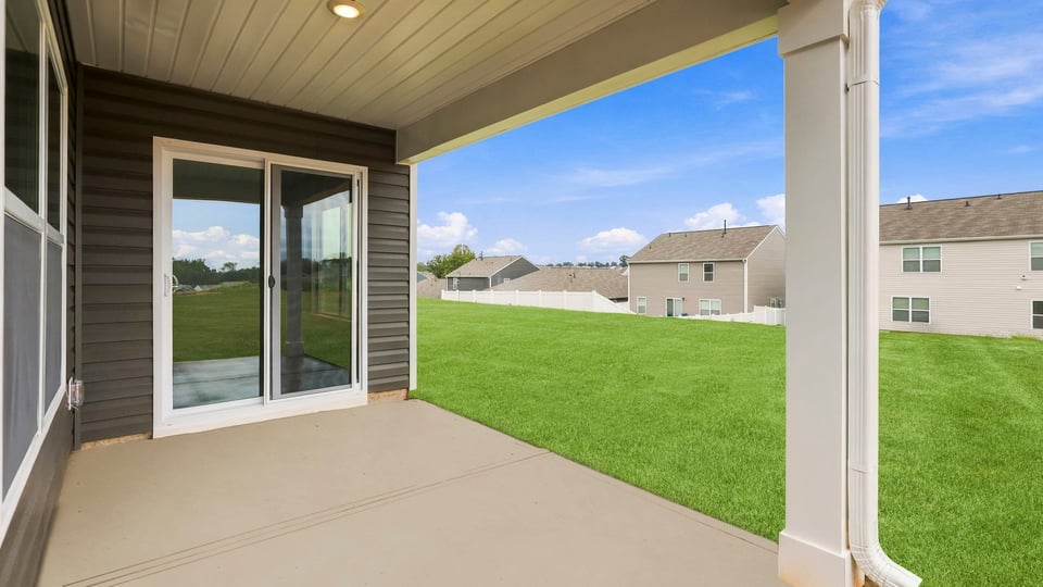 Back exterior of home with covered patio.