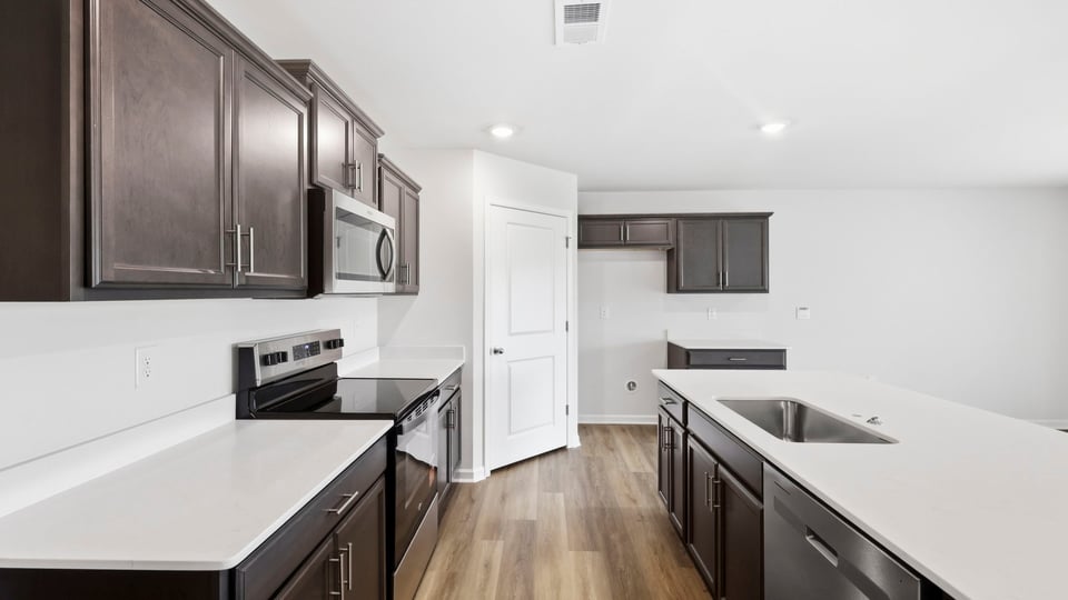 Kitchen and island with stainless steel appliances.