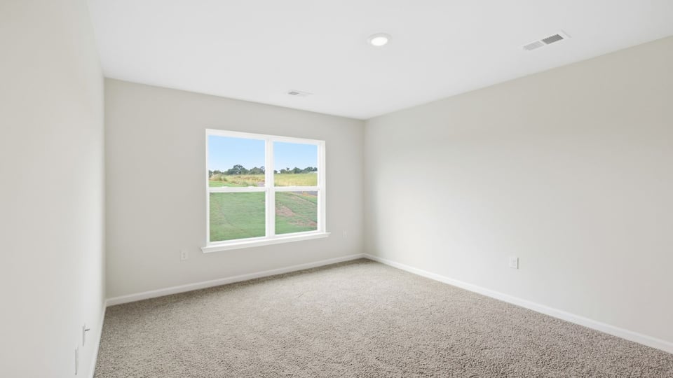 Bedroom with carpet and window.