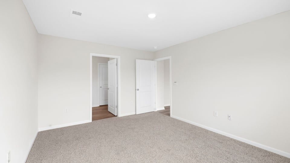 Bedroom with carpet and window.