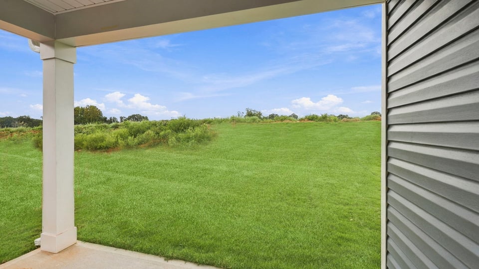 Back exterior of home with covered patio.