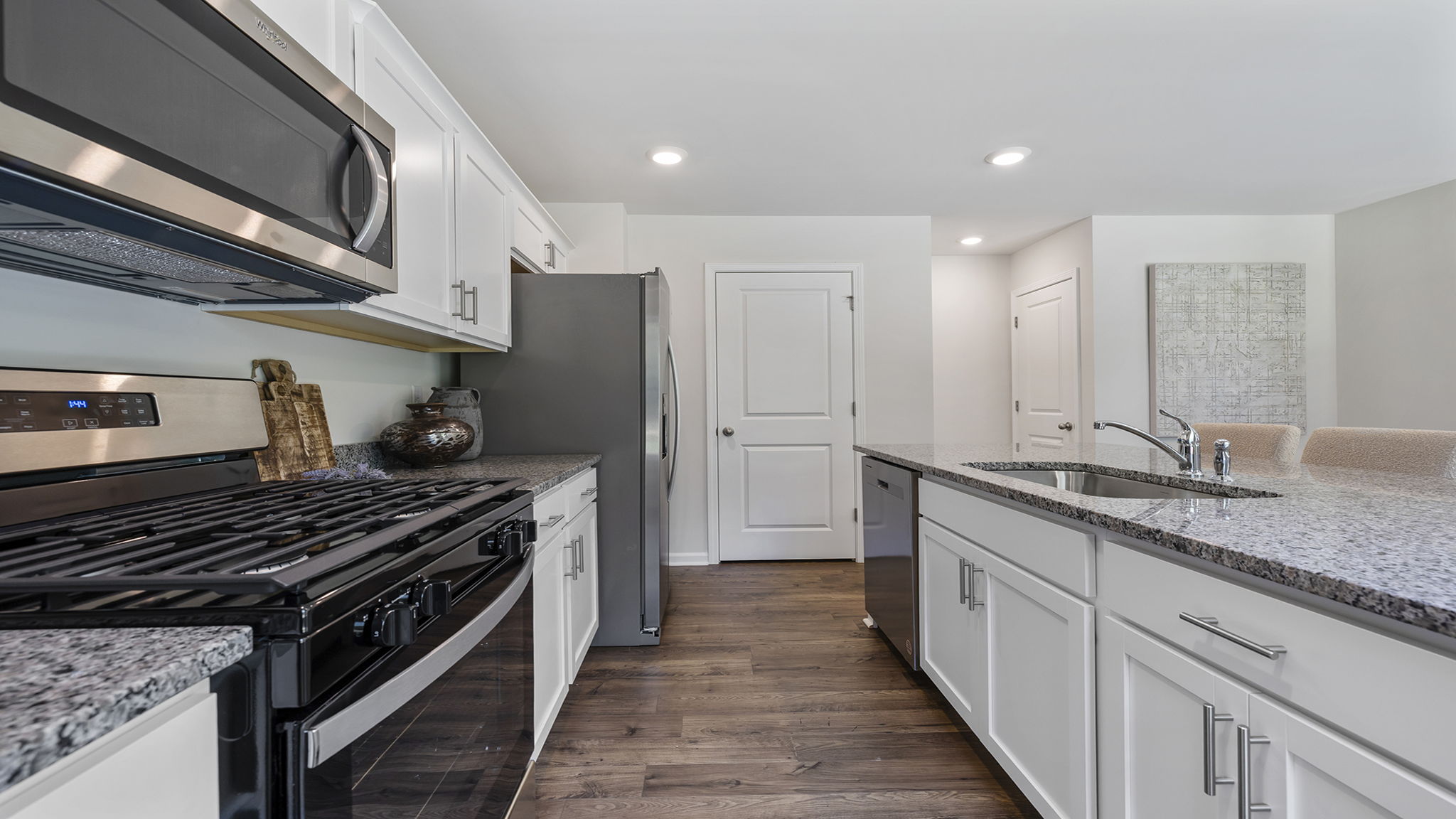 Kitchen and island with stainless steel appliances.