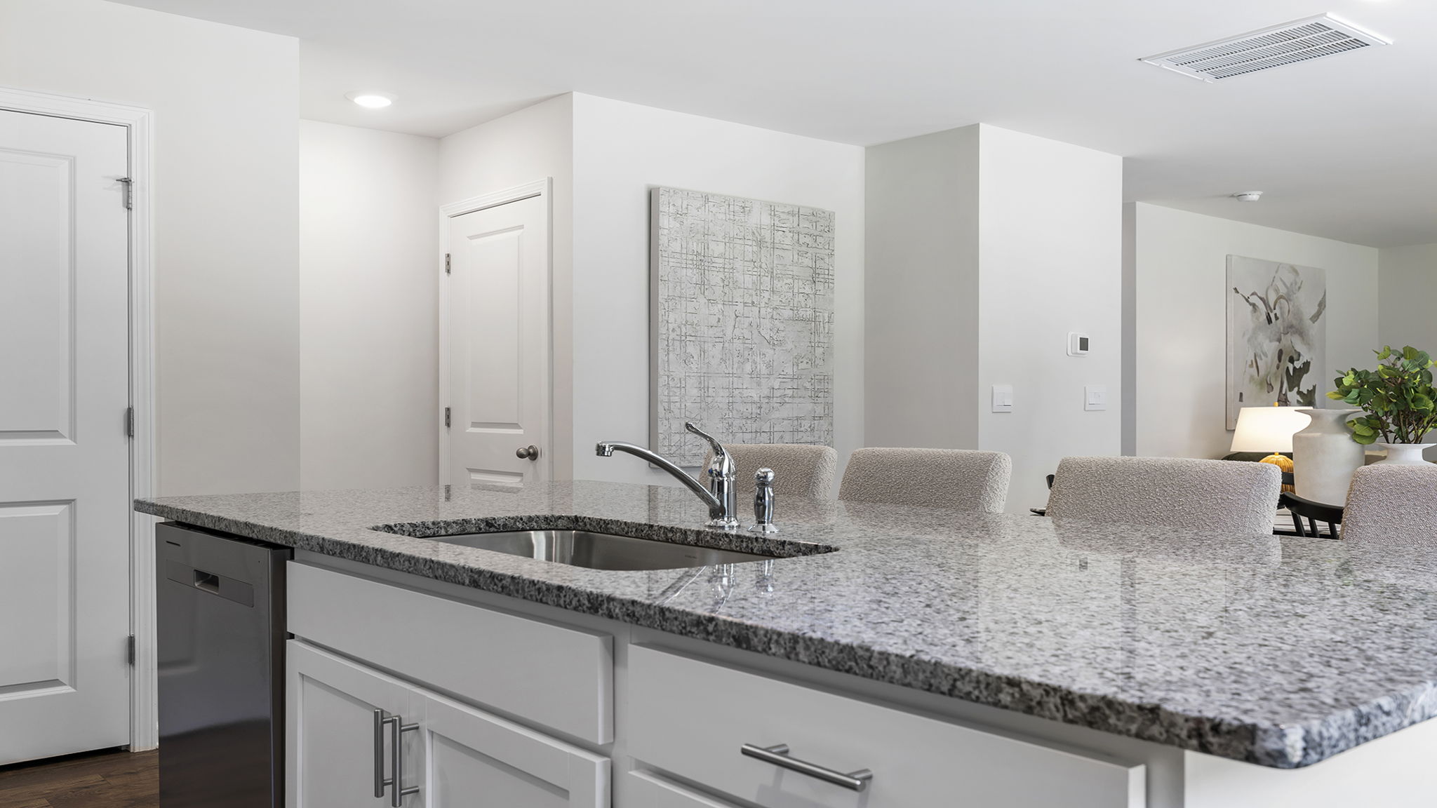 Kitchen and island with stainless steel appliances.