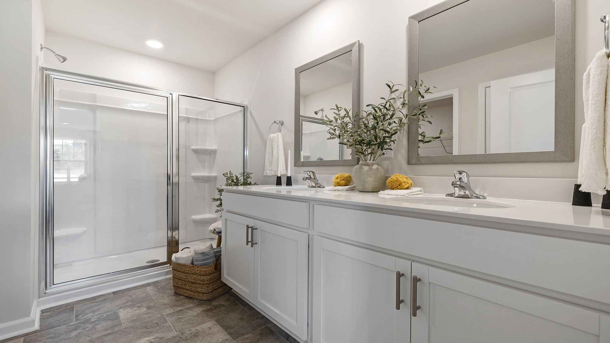 Bathroom with double vanity sink and walk in shower.
