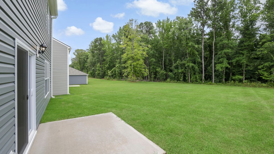 Back exterior of home with patio.