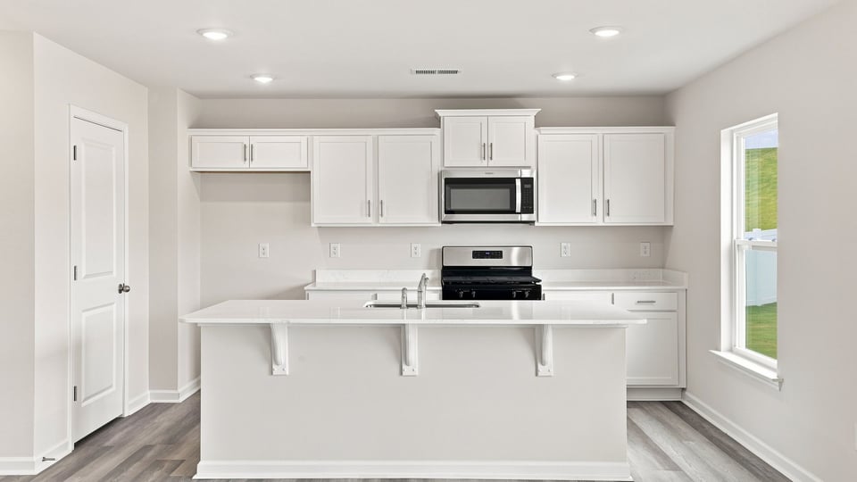 Kitchen with island and cabinets.