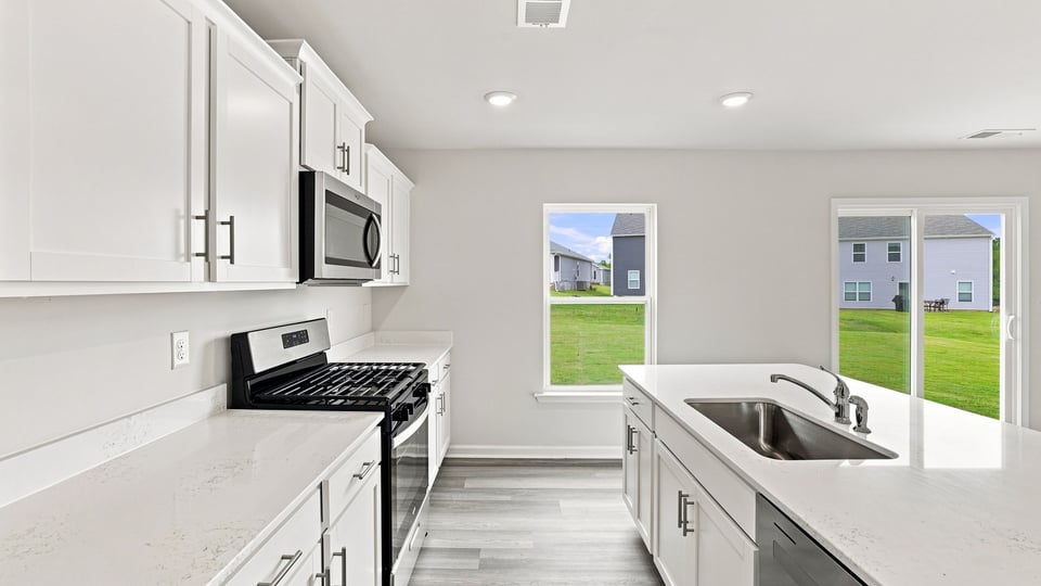 Kitchen with island and cabinets.