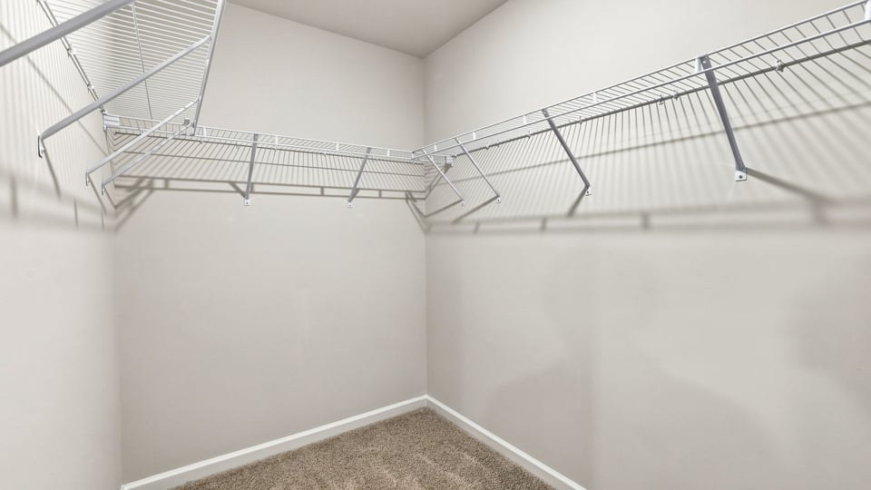 Primary closet with shelf.