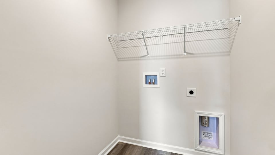 Laundry room with shelf.