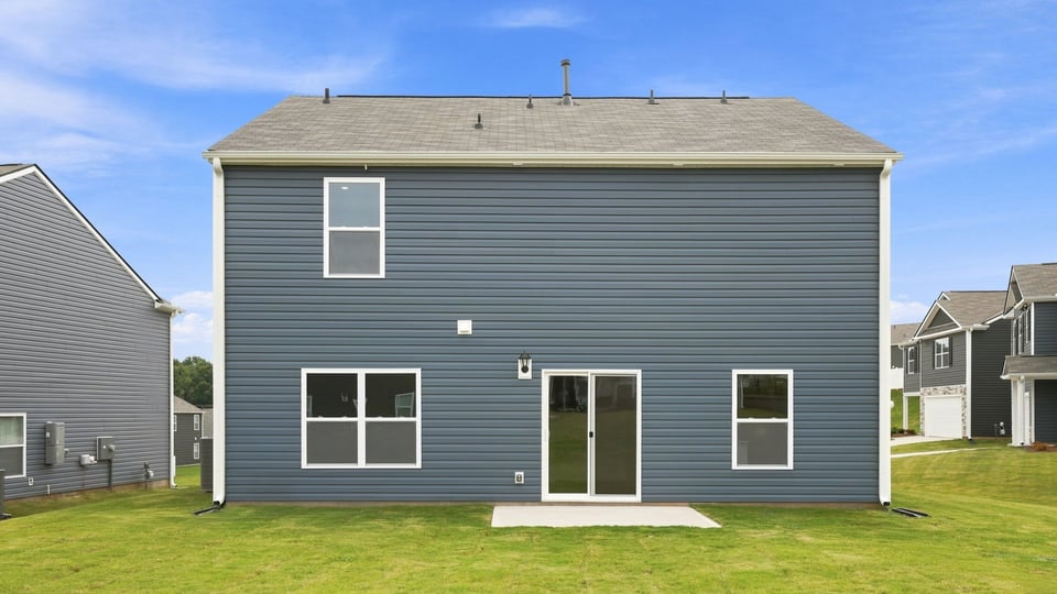 Exterior of home with large backyard.