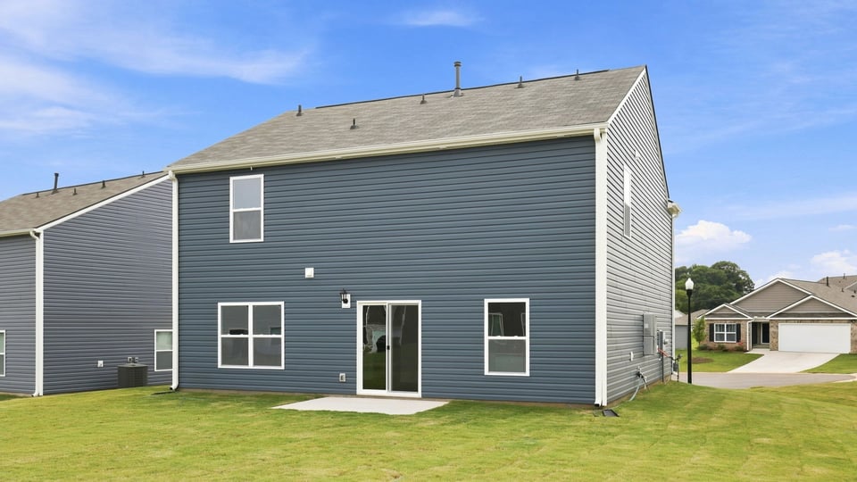 Exterior of home with large backyard.