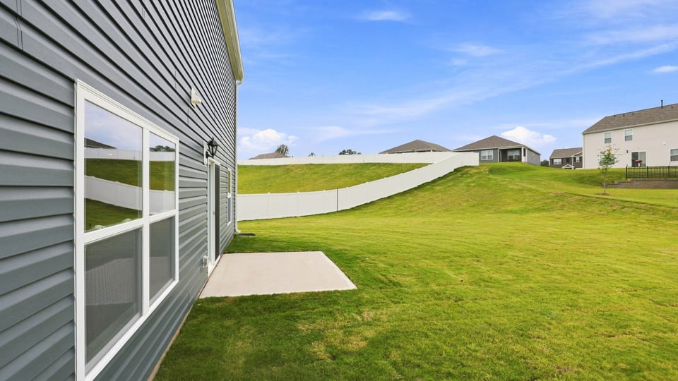 Exterior of home with large backyard.
