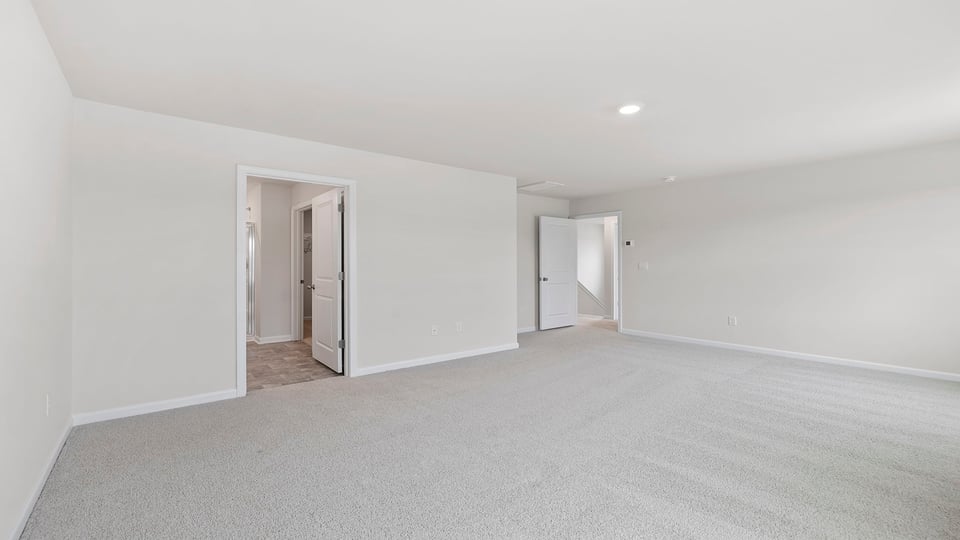 Bedroom with carpet and window.