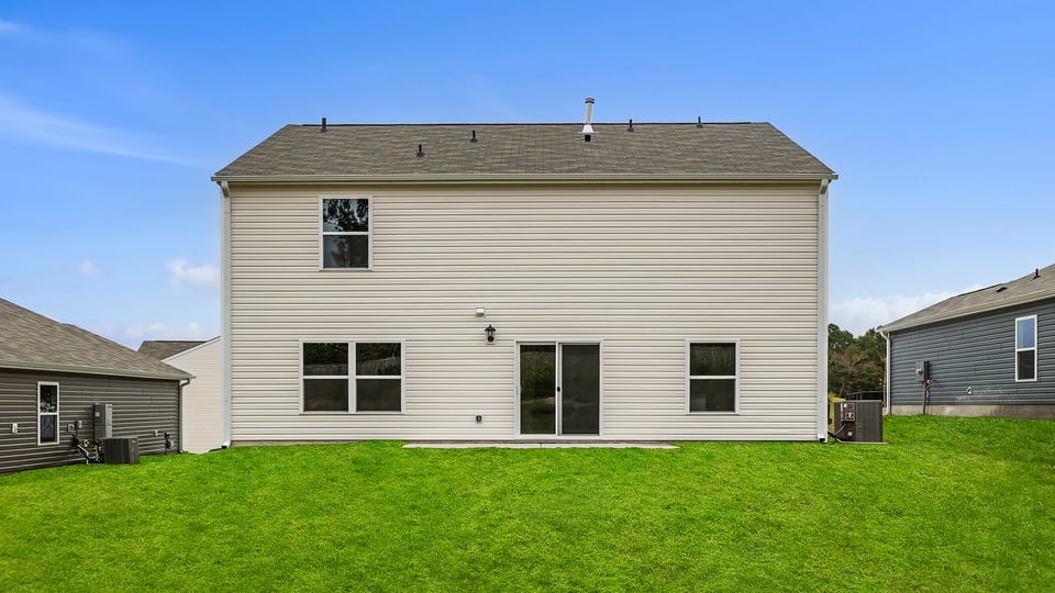 Exterior of home with large backyard.