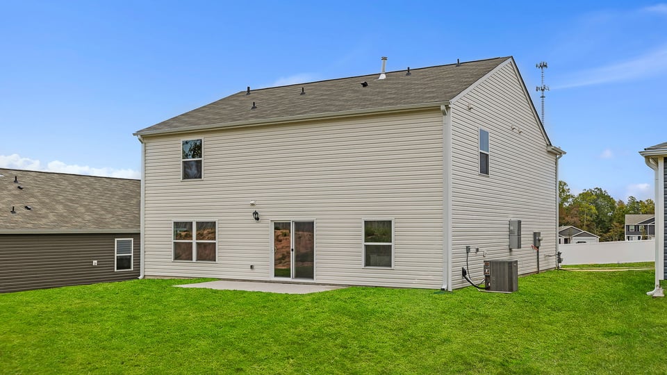 Exterior of home with large backyard.