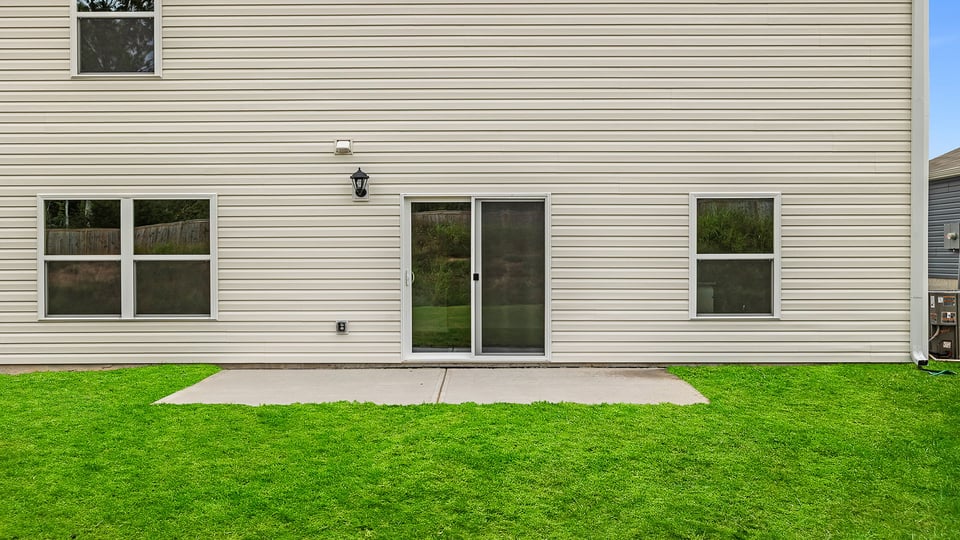 Exterior of home with large backyard.