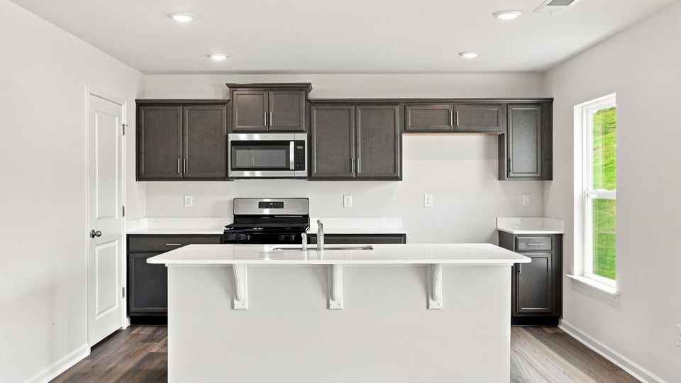 Kitchen with island and cabinets.