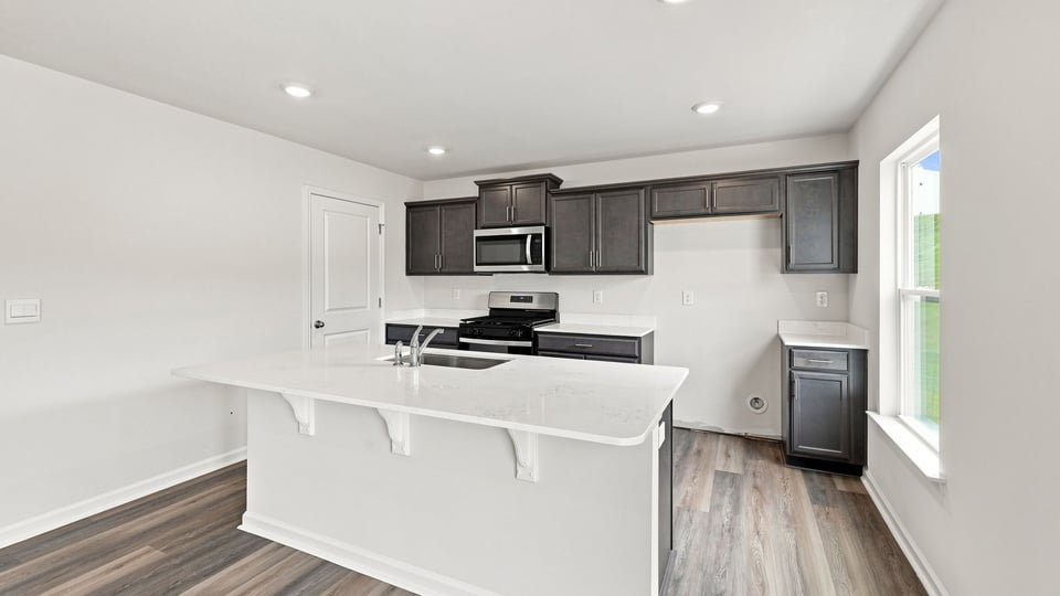 Kitchen with island and cabinets.