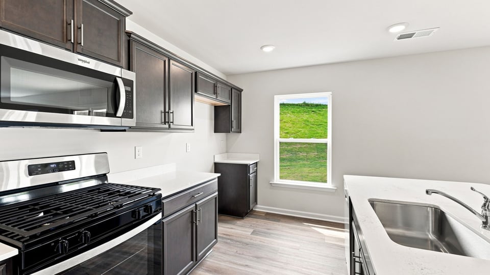 Kitchen with island and cabinets.