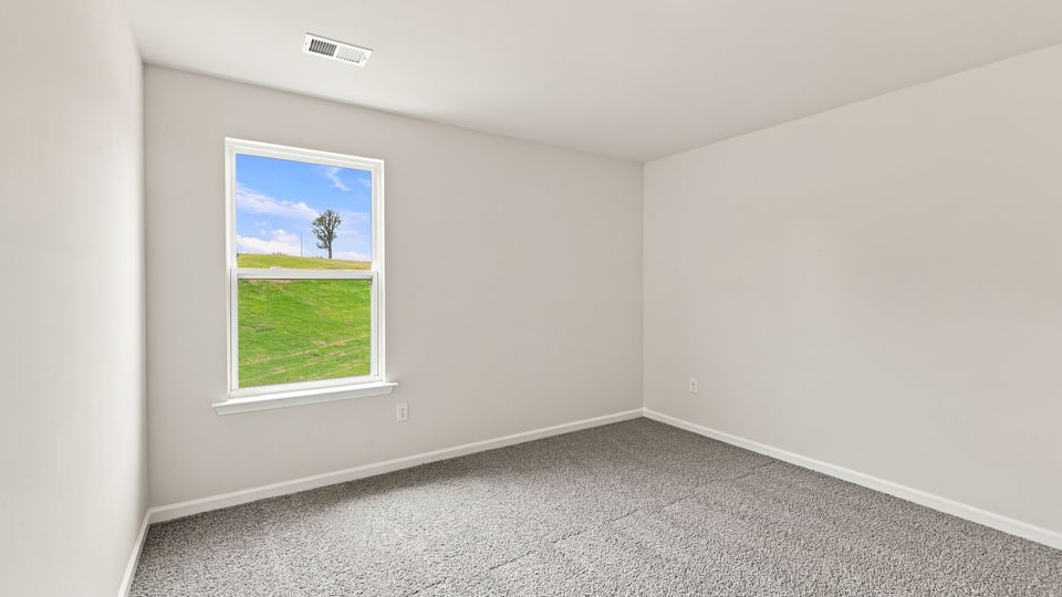 Bedroom with carpet and windows.