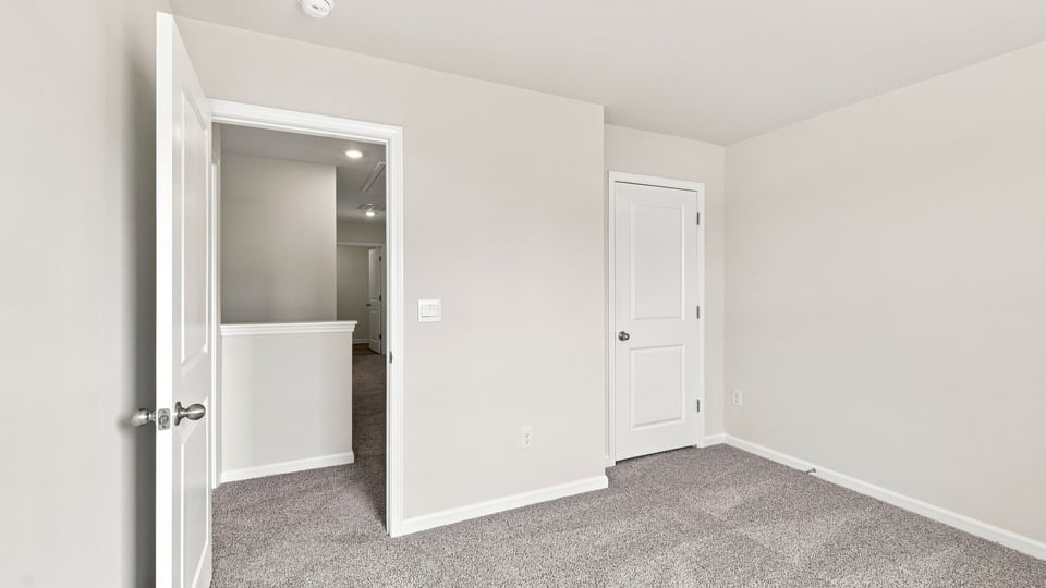 Bedroom with carpet and windows.