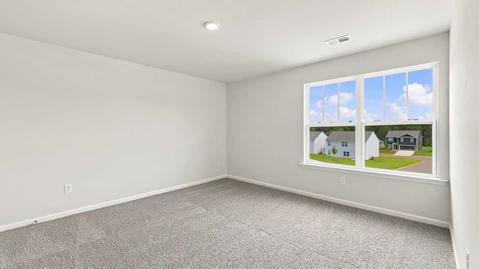 Bedroom with carpet and windows.