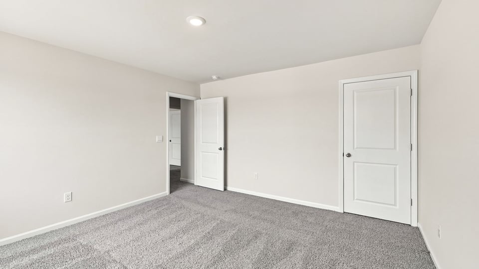 Bedroom with carpet and windows.