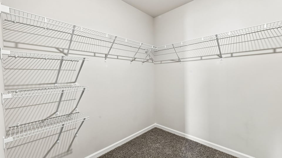 Primary closet with shelf.