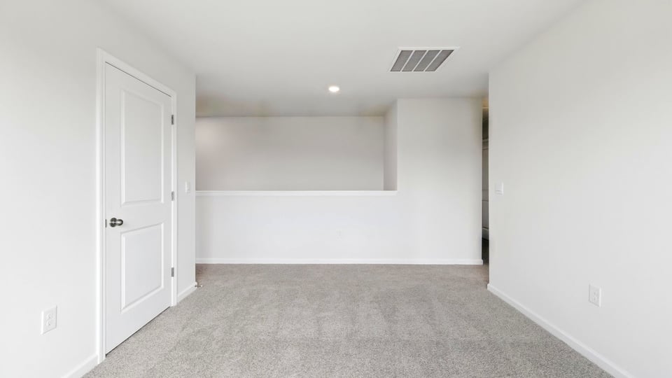 Bedroom with carpet and windows.