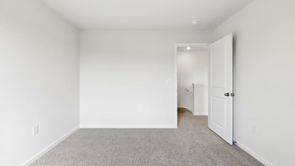 Bedroom with carpet and windows.