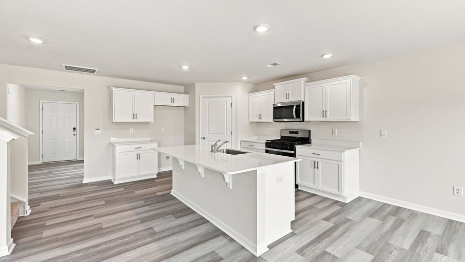 Kitchen with island and cabinets.
