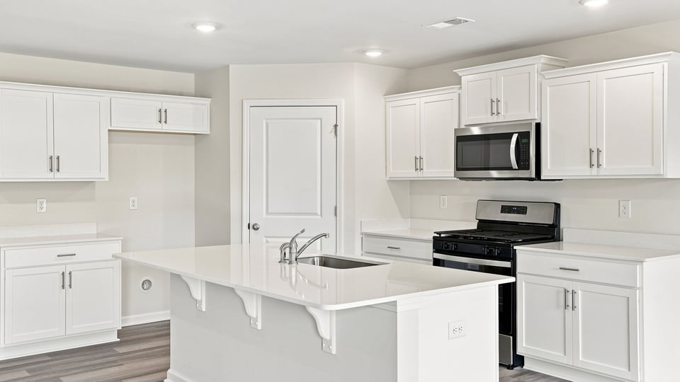 Kitchen with island and cabinets.