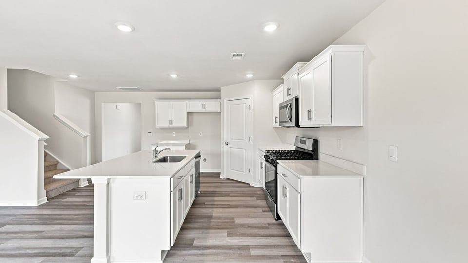 Kitchen with island and cabinets.