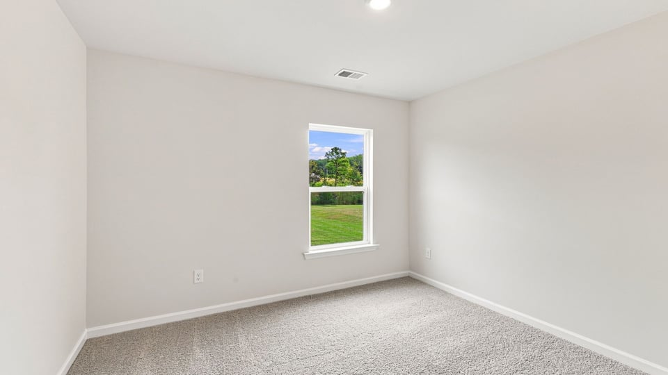 Bedroom with carpet and windows.