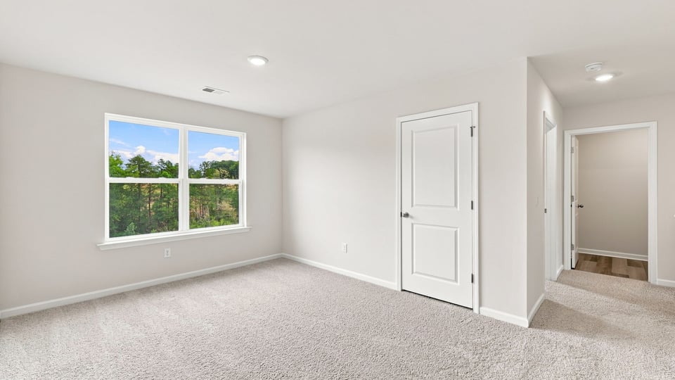 Loft with carpet and window.