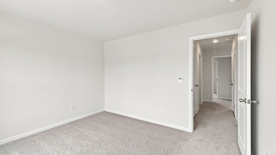 Bedroom with carpet and window.
