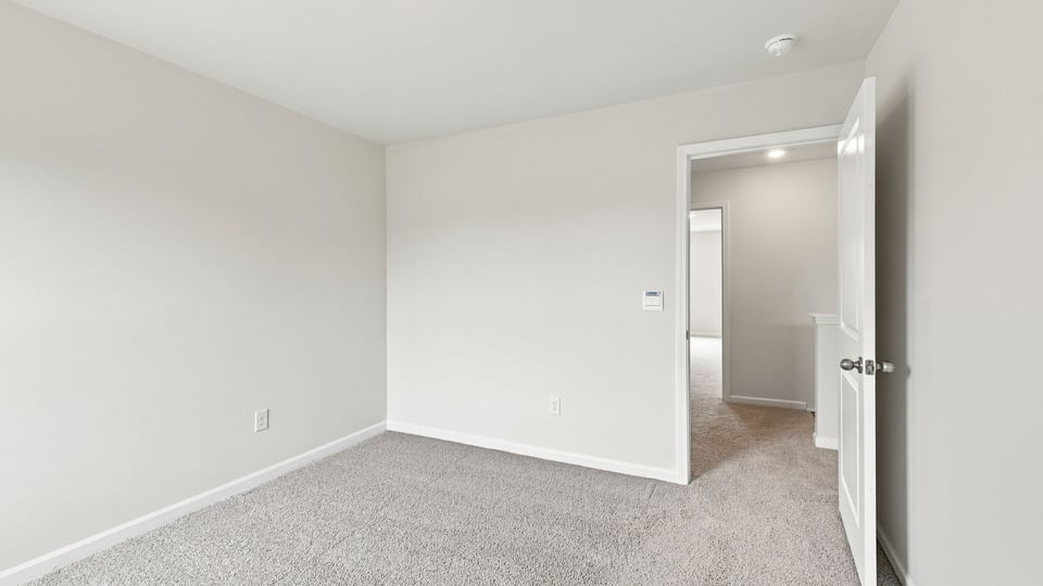 Bedroom with carpet and window.