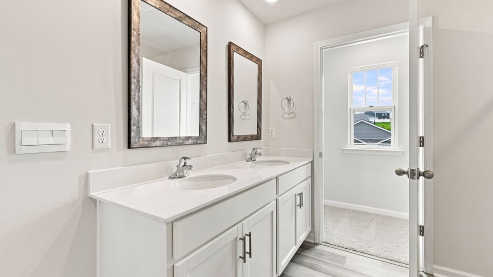 Primary bathroom with vanity sinks.